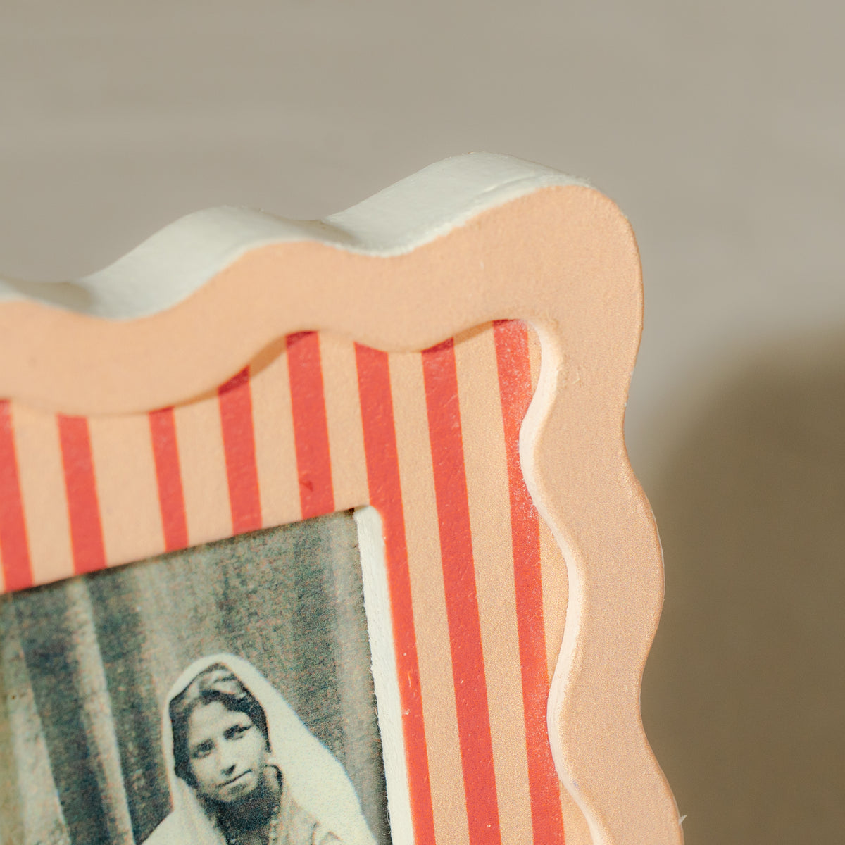 Set of three wavy wooden Instax Mini photo frames in taupe peach and warm red