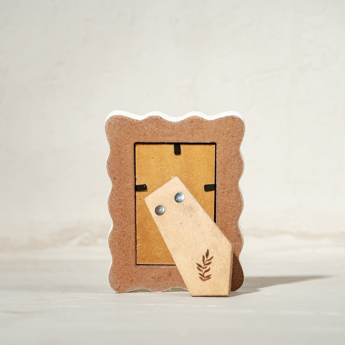 Set of three wavy wooden Instax Mini photo frames in taupe peach and warm red