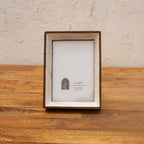 Niche natural wood and white photo frame displayed vertically