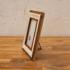 Side view of the white wooden photo frame with easel stand