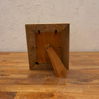 Back view of the white wooden photo frame with easel stand and wall hooks