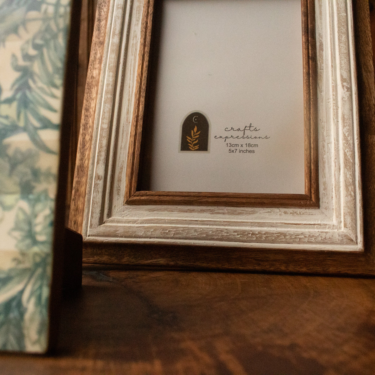 Close-up of the layered white and natural wood finish on the photo frame