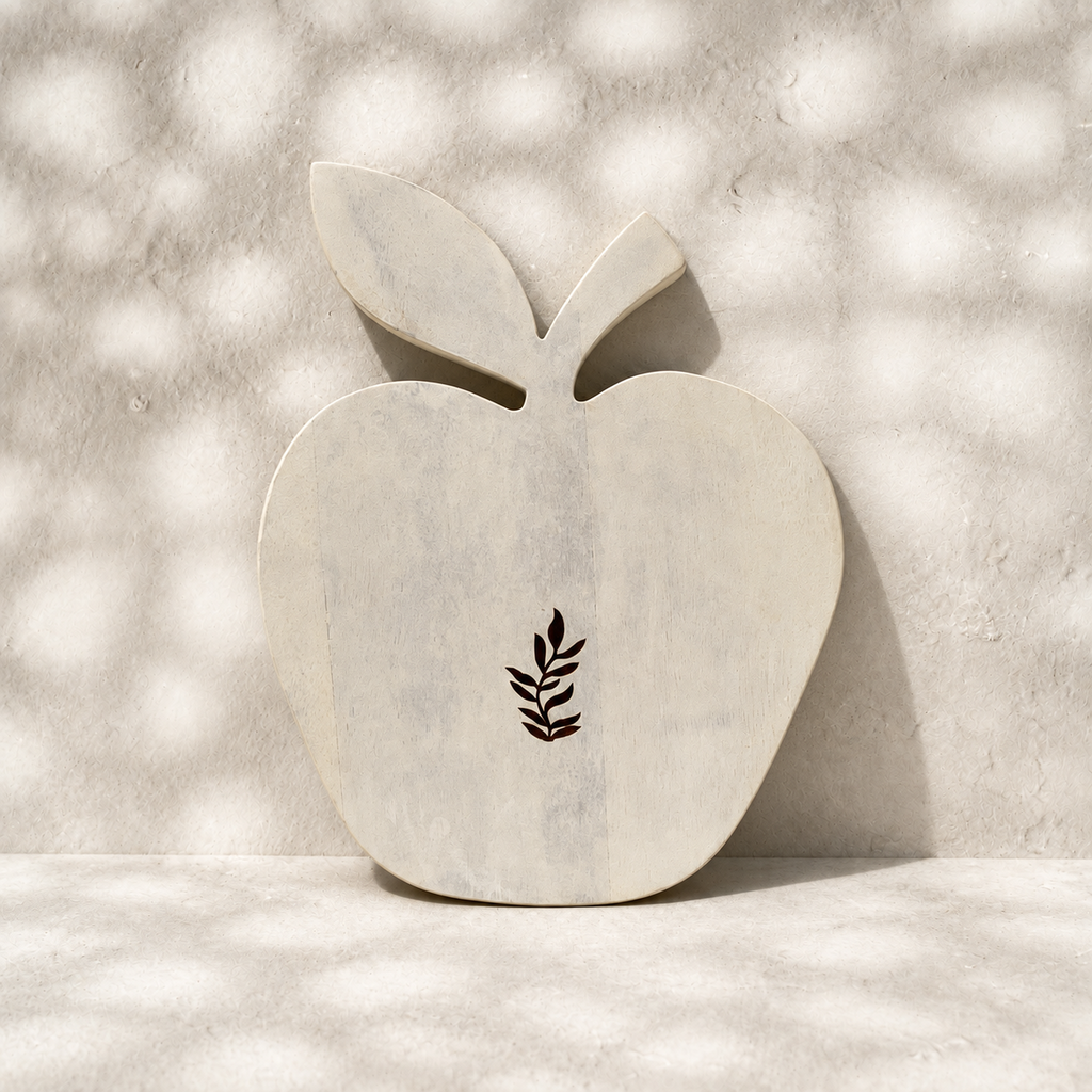 Front view of the whitewashed Orchard apple-shaped trivet with leaf motif