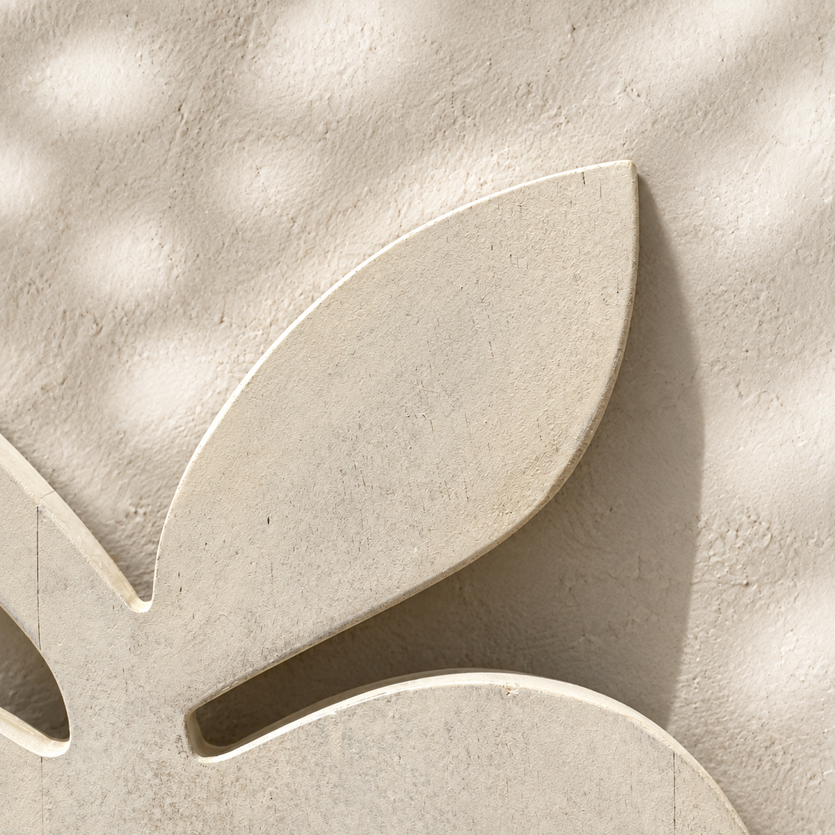 Close-up of the leaf detail on the whitewashed Orchard apple-shaped trivet