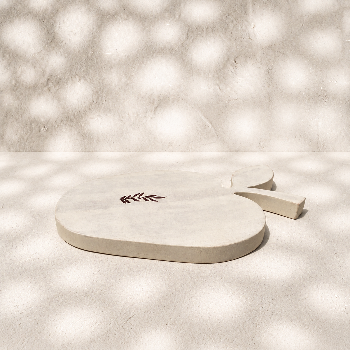 Low side view of the whitewashed Orchard apple-shaped wooden trivet
