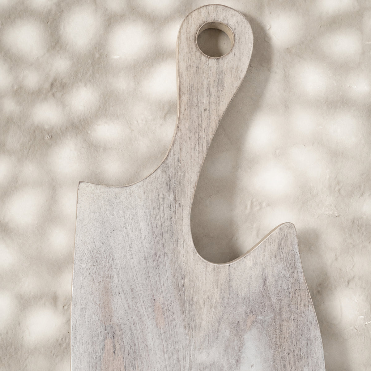 Close-up of the plain whitewashed Freeform wooden serving board