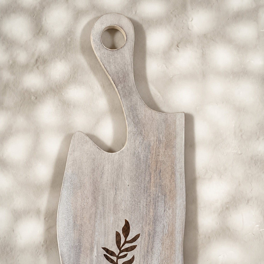 Close-up of the whitewashed Freeform wooden serving board with leaf motif