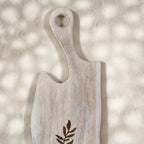 Close-up of the whitewashed Freeform wooden serving board with leaf motif