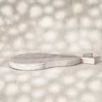 Low side view of the whitewashed Orchard pear-shaped wooden trivet