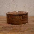 Front view of the closed round wooden roti box
