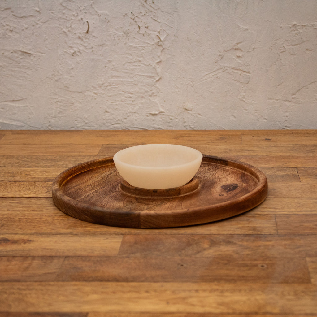Wooden chip and dip platter displayed with its round bowl