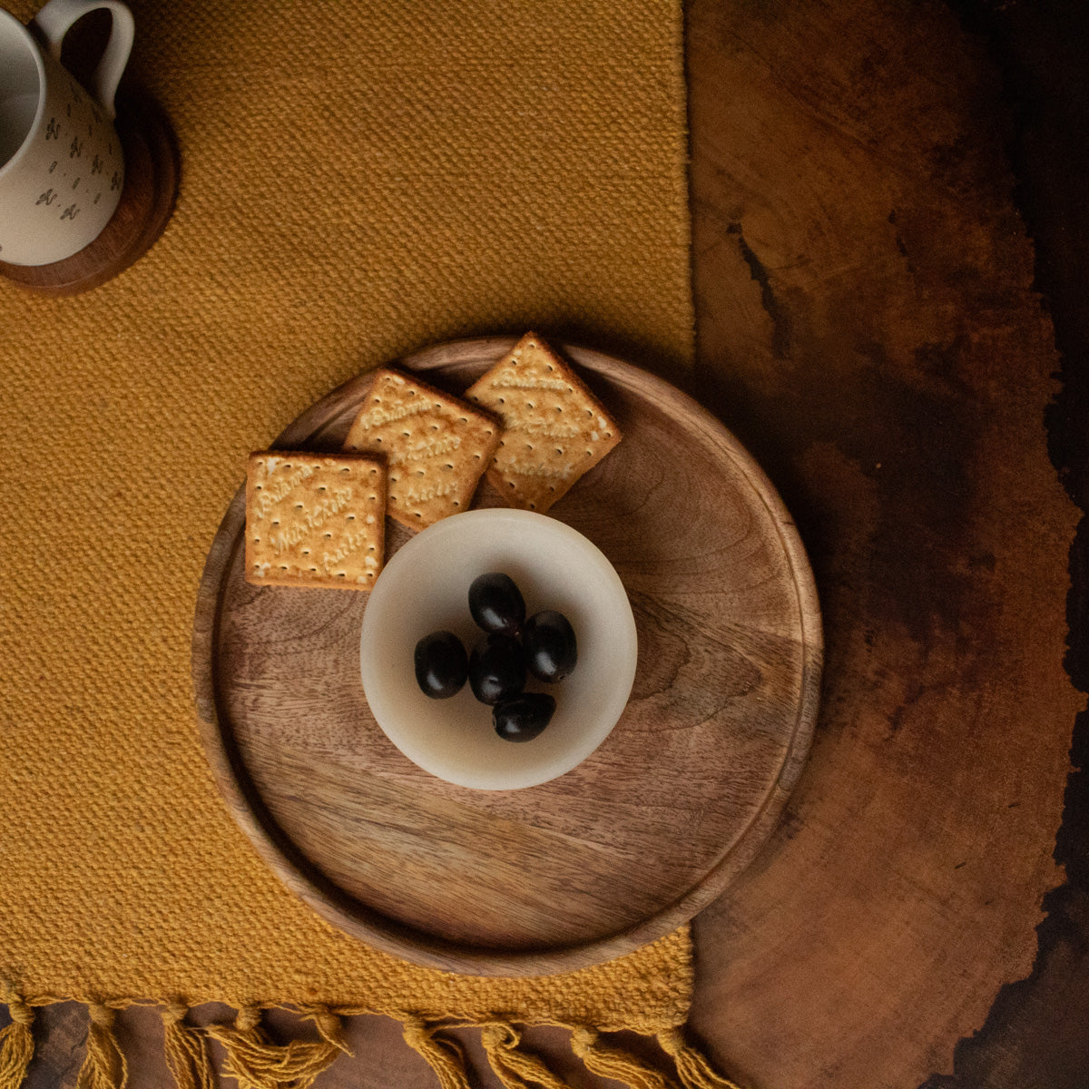 Wooden chip and dip platter styled with biscuits and a filled bowl