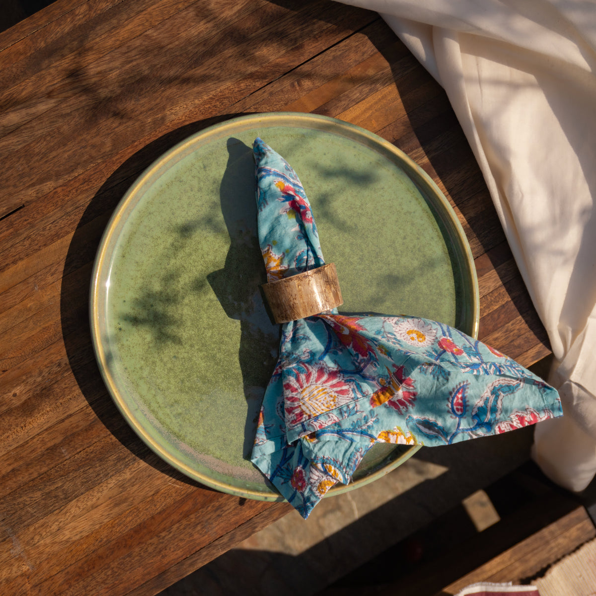 Basic horn napkin ring styled with a printed napkin on a table