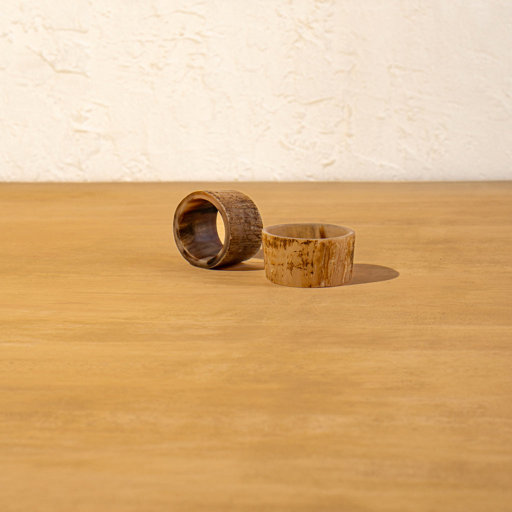 Basic horn napkin ring lying flat on a wooden surface