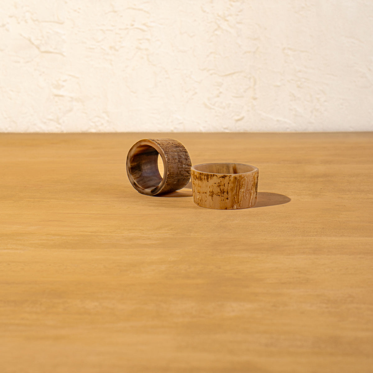 Basic horn napkin ring lying flat on a wooden surface