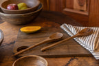 Ellipse wooden salad servers styled beside serving bowls