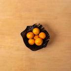Top view of the fluted resin serving bowl filled with oranges
