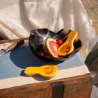 Fluted resin serving bowl styled with fruit on a table