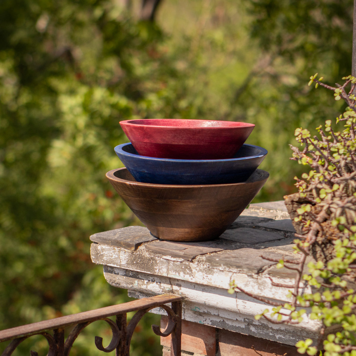 Large wooden bowl set stacked outdoors