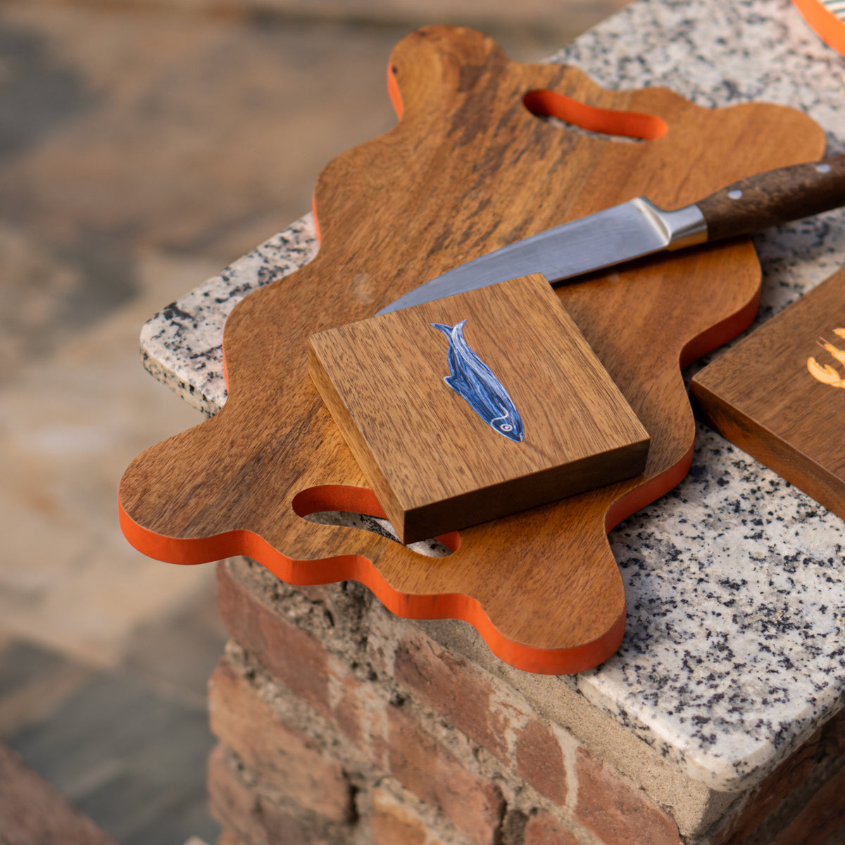 Marine wooden trivet holding a serving dish outdoors