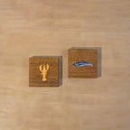 Two square Marine wooden trivets displayed side by side