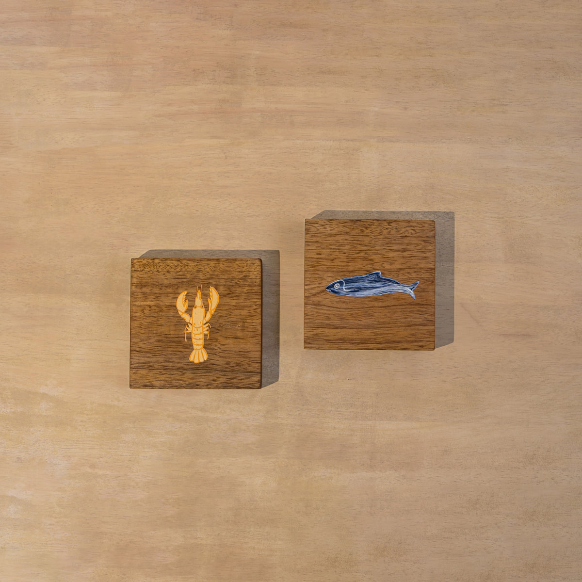 Two square Marine wooden trivets displayed side by side