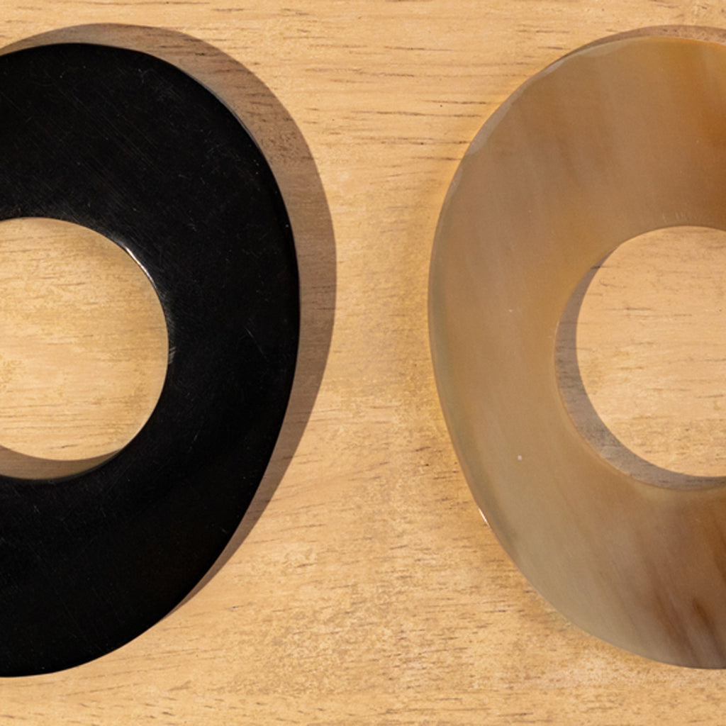 Close-up of black and translucent Orbit horn napkin rings