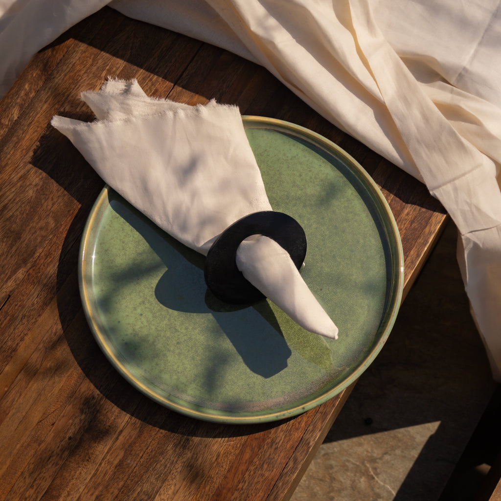 Orbit horn napkin ring styled with a folded napkin on a table