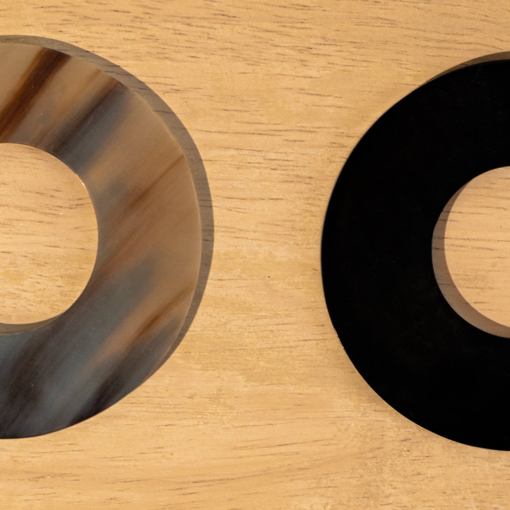 Close-up of black and translucent Polo horn napkin rings