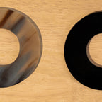 Close-up of black and translucent Polo horn napkin rings