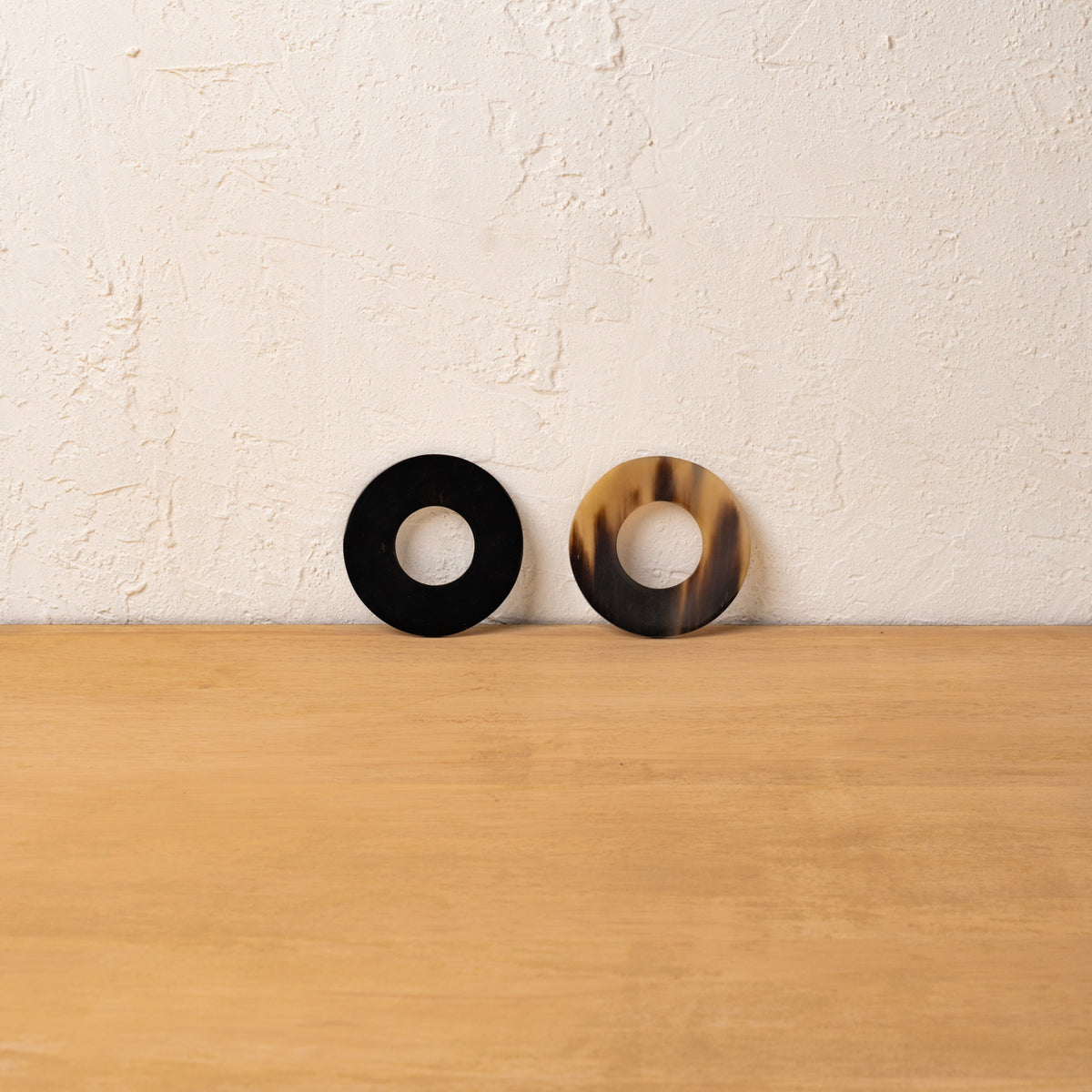 Black and golden Polo horn napkin rings displayed upright