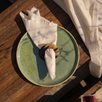 Polo horn napkin ring styled with a folded napkin on a plate