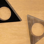 Close-up of black and translucent Pyramid horn napkin rings