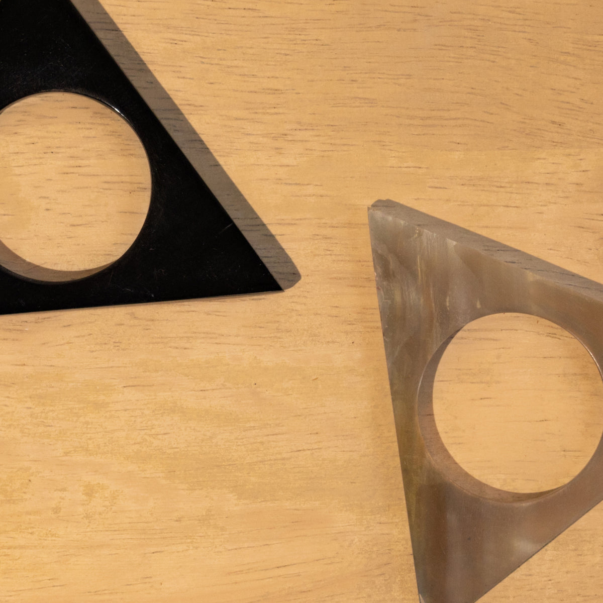 Close-up of black and translucent Pyramid horn napkin rings