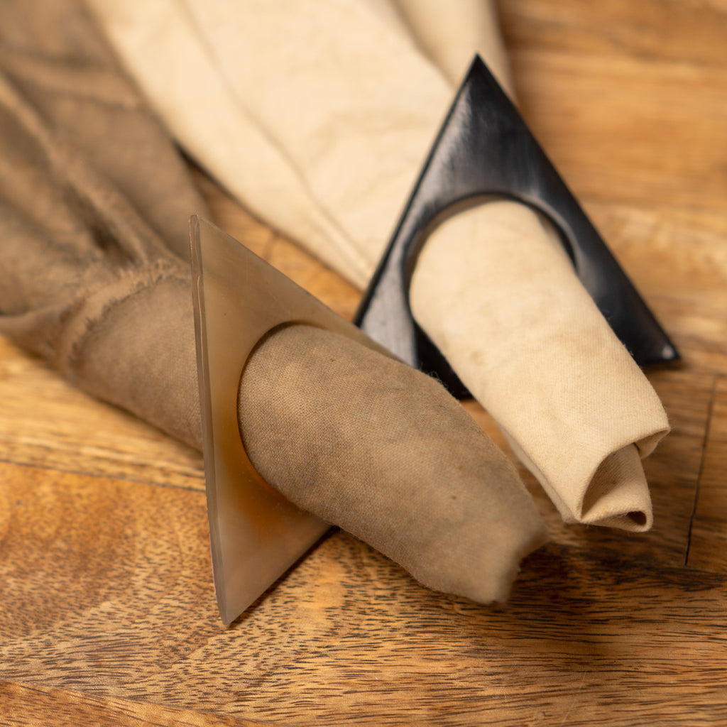 Pyramid horn napkin ring styled with a folded beige napkin