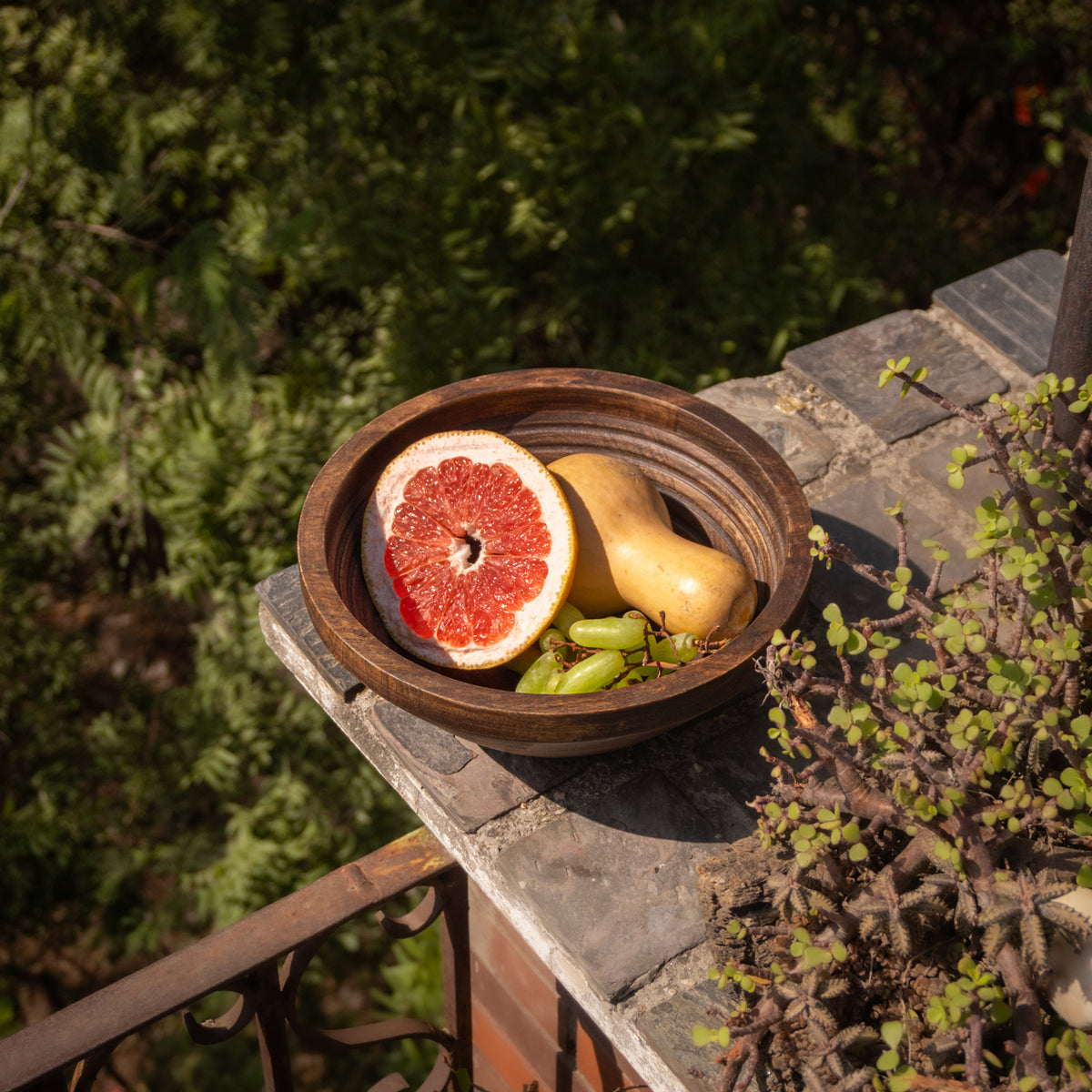 Ridge wooden bowl styled with fruit outdoors
