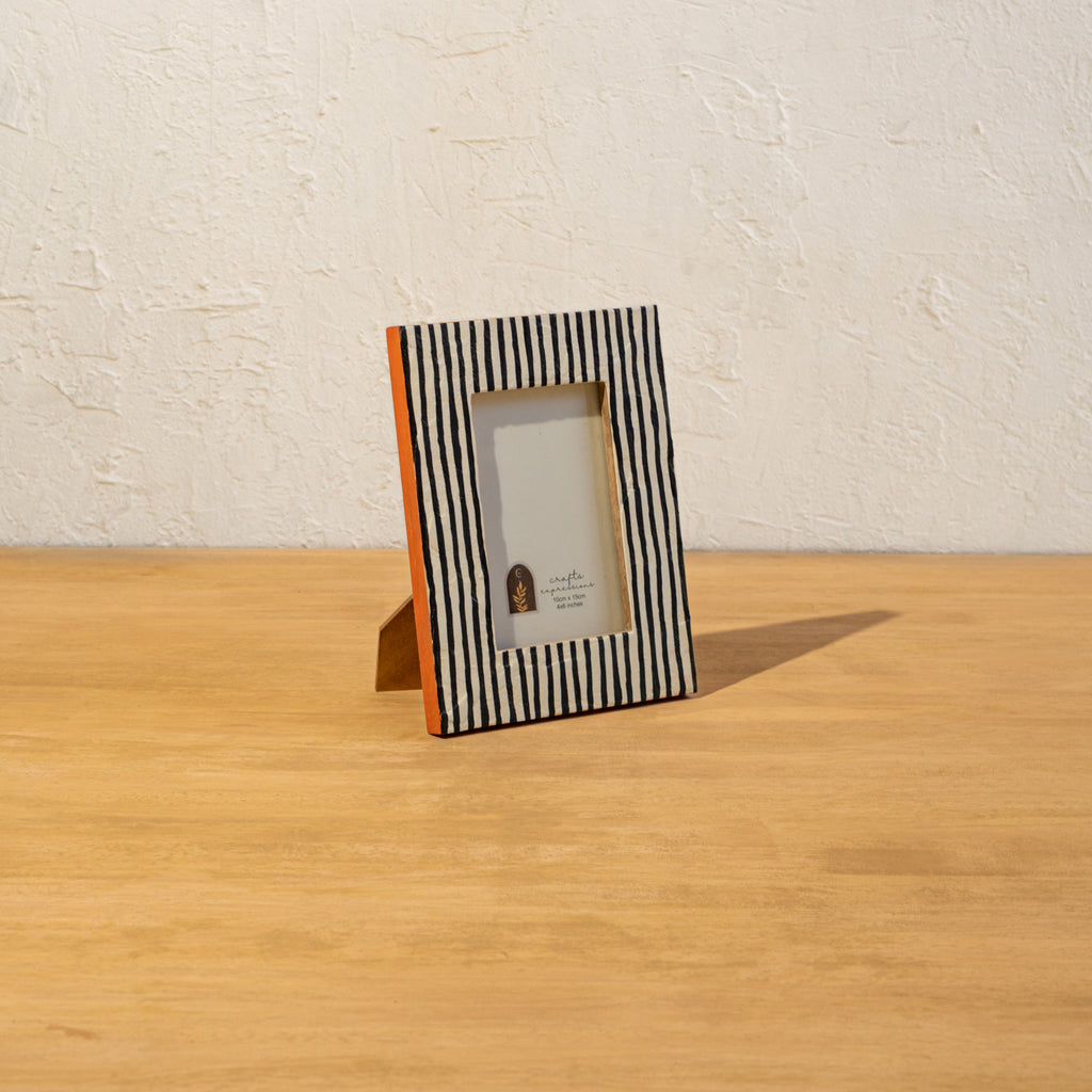 Angled view of the striped wooden photo frame with easel stand