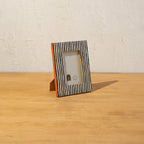 Angled view of the striped wooden photo frame with easel stand