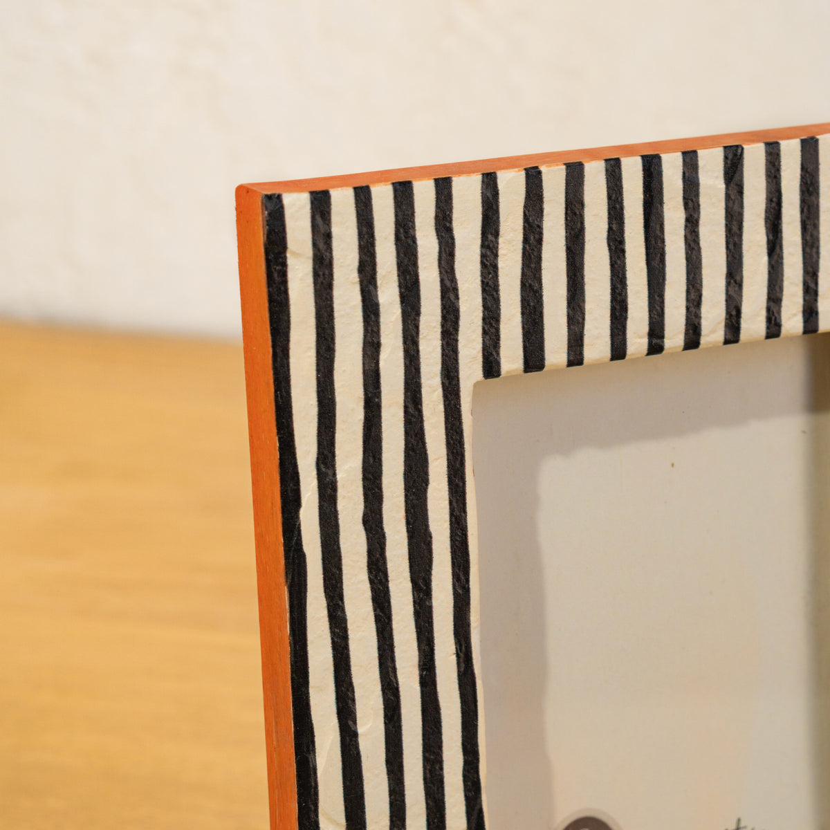 Close-up of the black-and-white stripes and orange edge on the photo frame