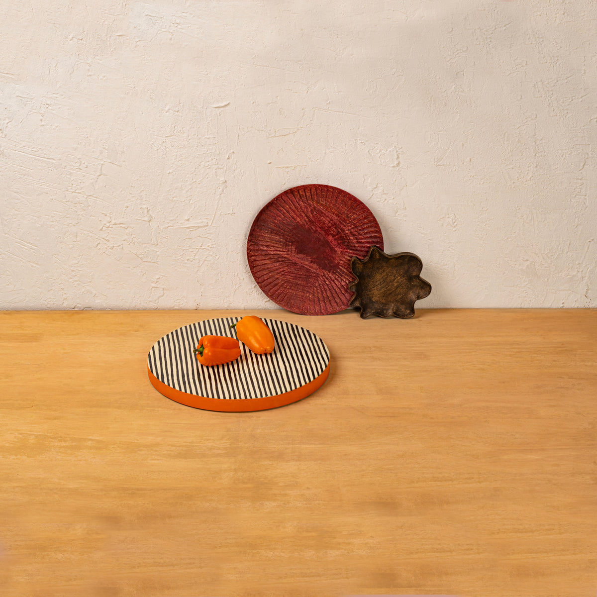 Striped wooden platter set displayed with fruit