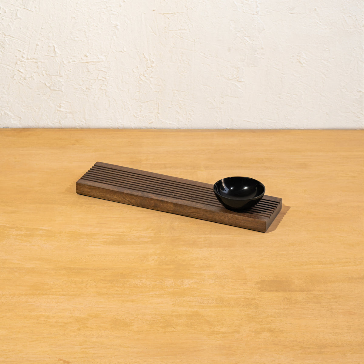 Front view of the Sushi wooden board and dip bowl