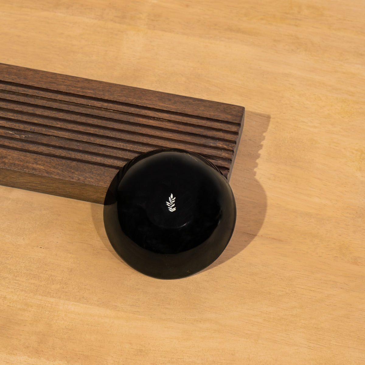 Close-up of the dip bowl beside the Sushi wooden board