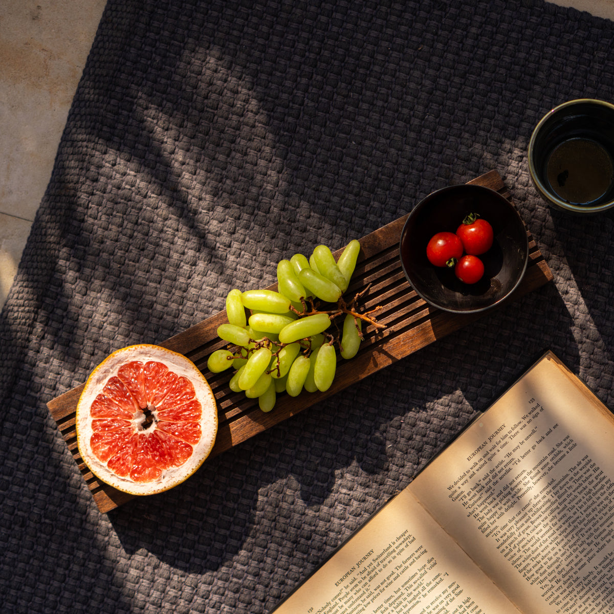 Sushi wooden board styled with fruit and bowls