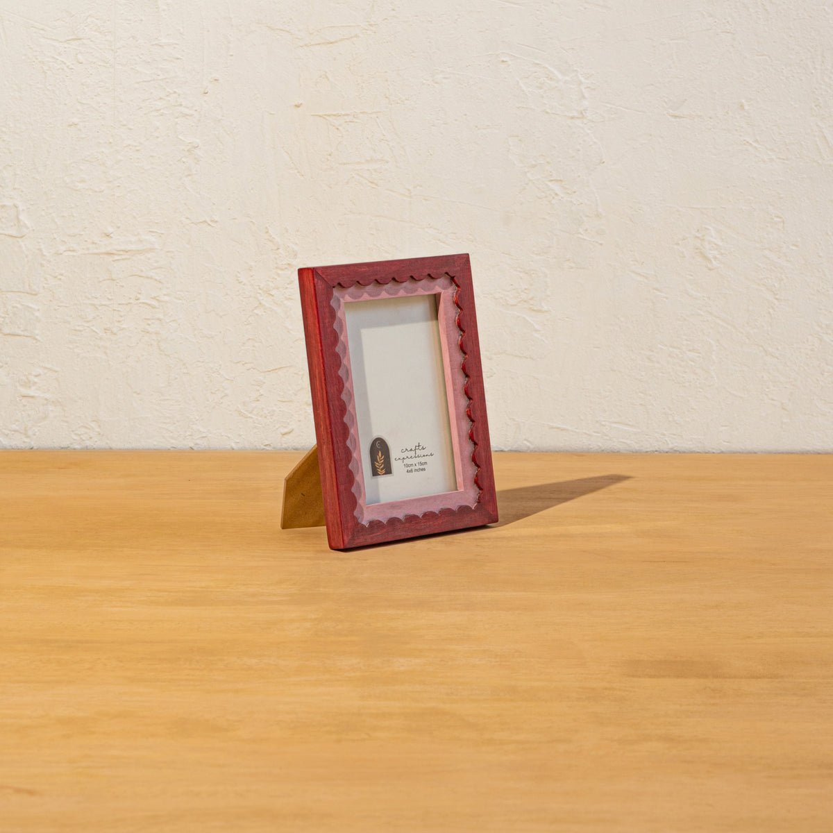 Side view of the red wavy wooden photo frame and easel stand