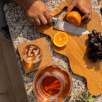 Wavy wooden platter styled with food on a table
