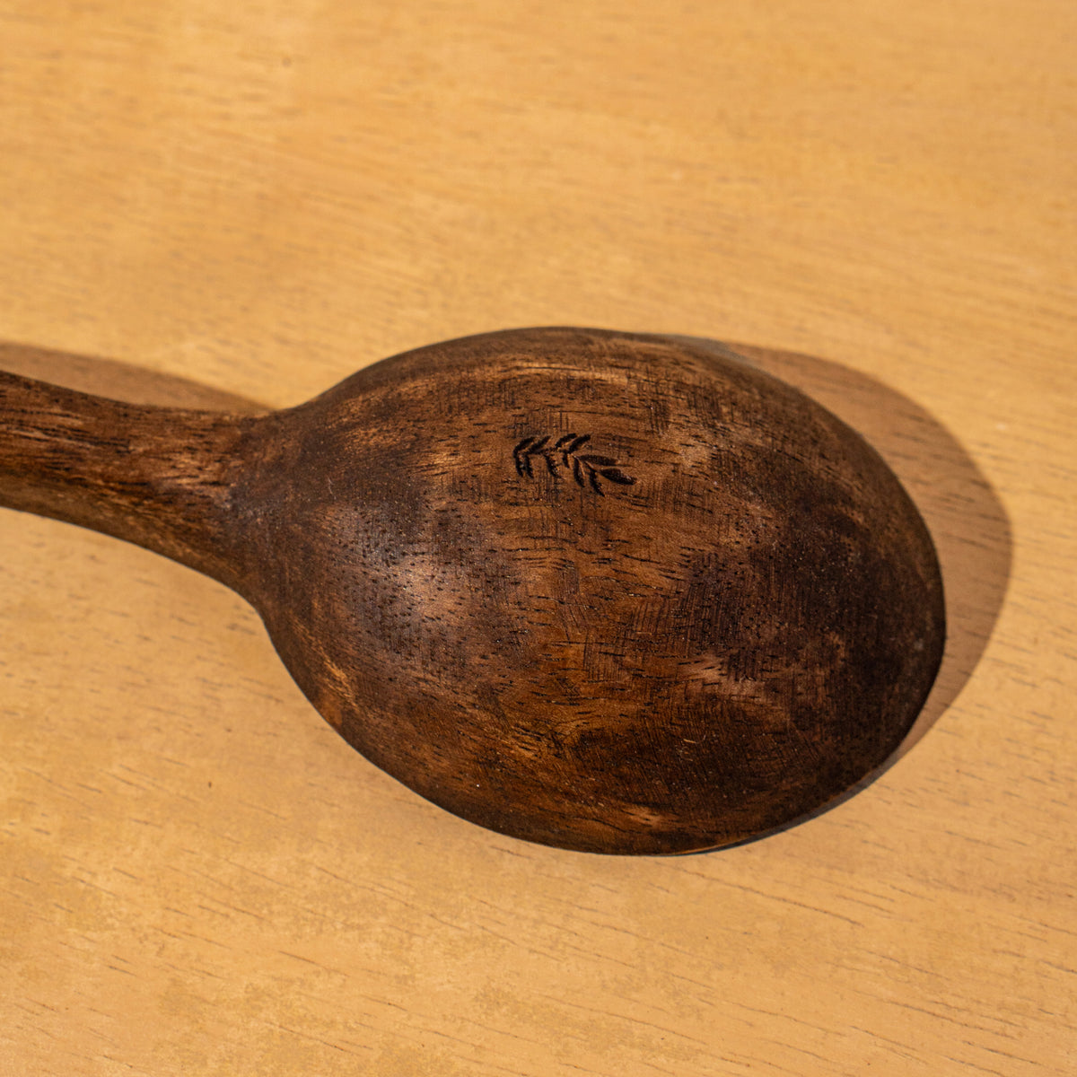 Close-up of a Wavy wooden salad serving spoon