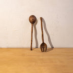 Three Wavy wooden salad servers displayed upright