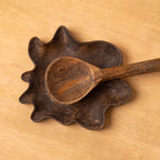Top view of the Wavy wooden spoon rest holding a spoon